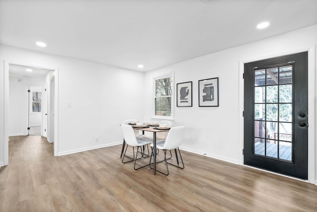 dining space with a healthy amount of sunlight, light wood-style flooring, and recessed lighting