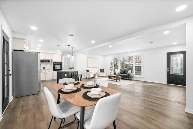 dining space featuring light wood-style floors and recessed lighting