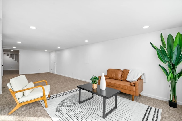 living area with recessed lighting, light carpet, and baseboards