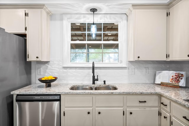 kitchen featuring stainless steel appliances, pendant lighting, white cabinetry, and a sink