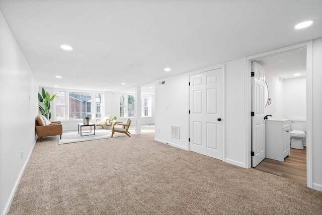 unfurnished living room with recessed lighting and light colored carpet