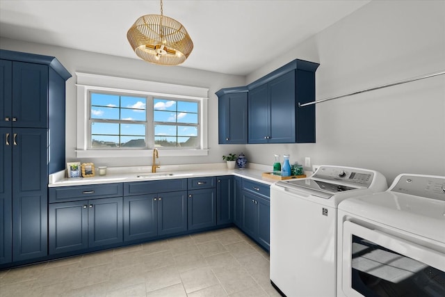 laundry area with cabinet space, independent washer and dryer, and a sink