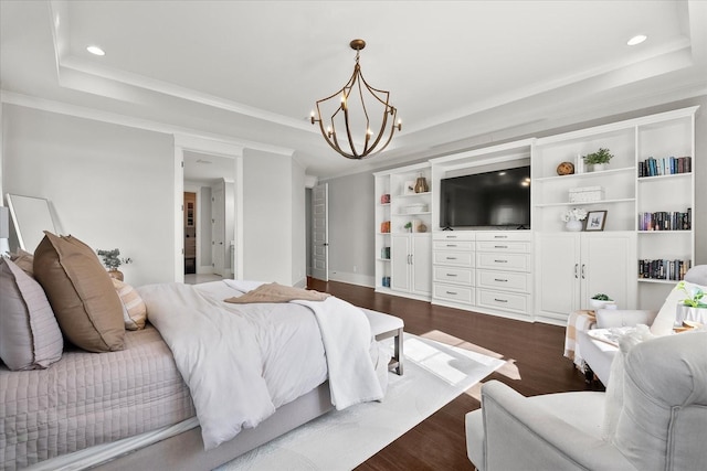 bedroom featuring a chandelier, recessed lighting, dark wood-type flooring, a raised ceiling, and crown molding