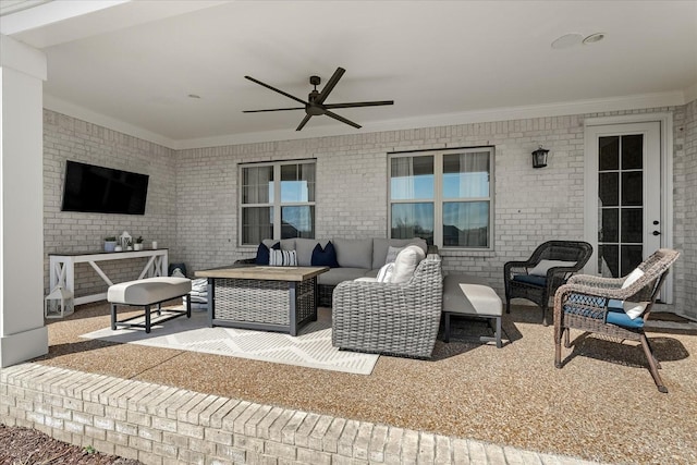 view of patio / terrace featuring a ceiling fan and an outdoor living space with a fire pit