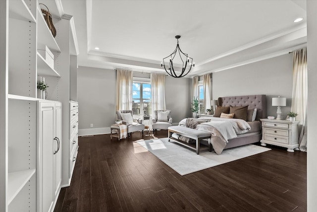 bedroom with baseboards, a raised ceiling, dark wood-type flooring, a notable chandelier, and recessed lighting