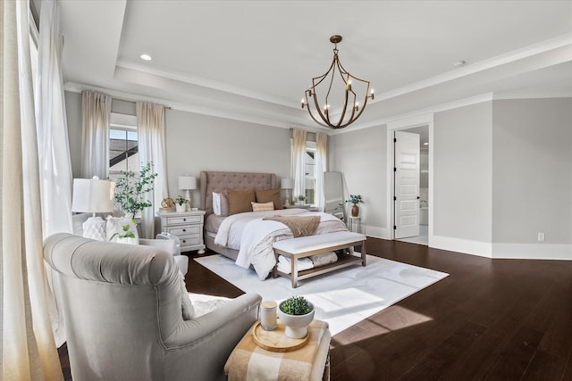 bedroom featuring a chandelier, wood finished floors, baseboards, ornamental molding, and a raised ceiling