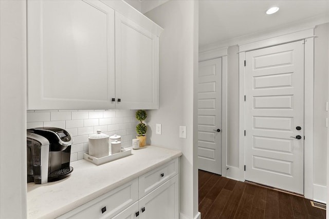 kitchen with recessed lighting, visible vents, white cabinetry, tasteful backsplash, and dark wood finished floors