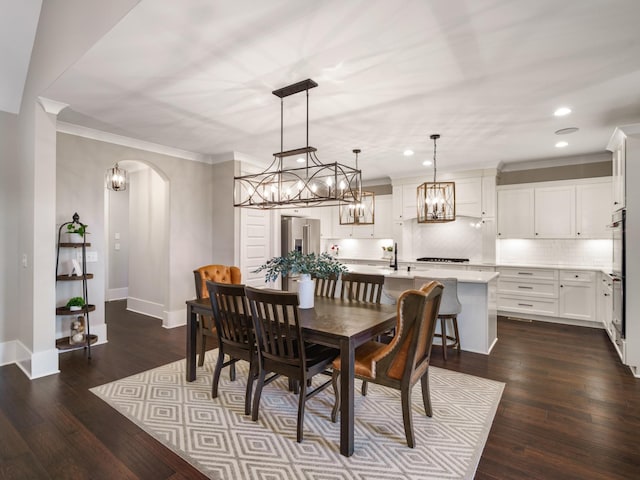 5562 Hardeman Springs Blvd, Arrington, TN 37014 - dining area featuring recessed lighting, crown molding, dark wood-type flooring, arched walkways, and baseboards