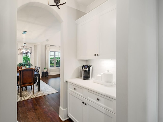 5562 Hardeman Springs Blvd, Arrington, TN 37014 - kitchen with a chandelier, dark wood-type flooring, arched walkways, and white cabinets
