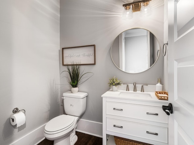 5562 Hardeman Springs Blvd, Arrington, TN 37014 - bathroom featuring vanity, toilet, wood finished floors, and baseboards