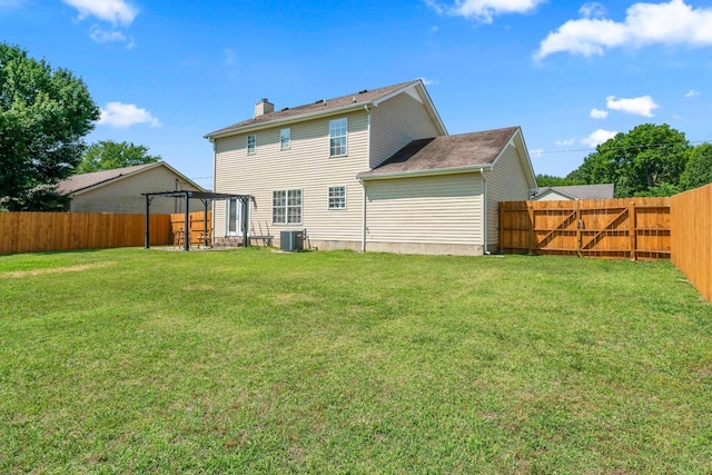 rear view of house with cooling unit, a fenced backyard, a yard, and a pergola