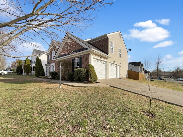 view of side of property with a yard, driveway, brick siding, and a garage