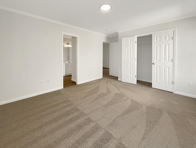 unfurnished bedroom featuring baseboards, a closet, carpet, and crown molding