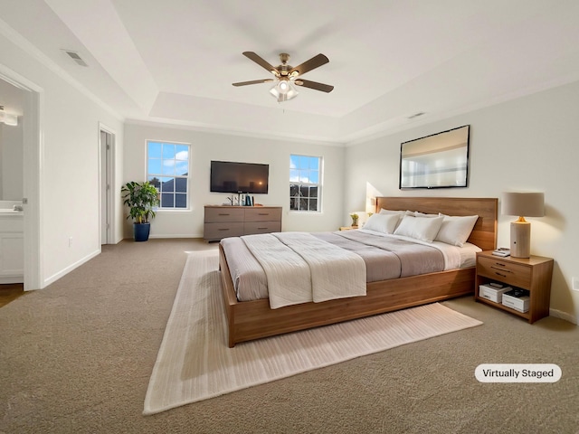 bedroom featuring ceiling fan, carpet flooring, a raised ceiling, and baseboards