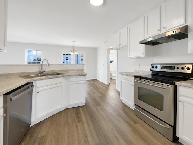 kitchen featuring under cabinet range hood, appliances with stainless steel finishes, and white cabinets