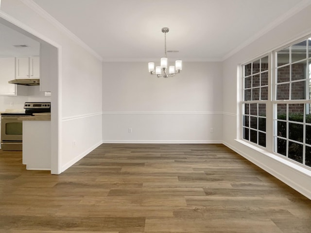 unfurnished dining area with baseboards, ornamental molding, wood finished floors, and a notable chandelier