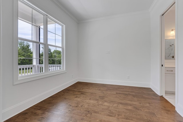 empty room with baseboards, ornamental molding, and dark wood-type flooring