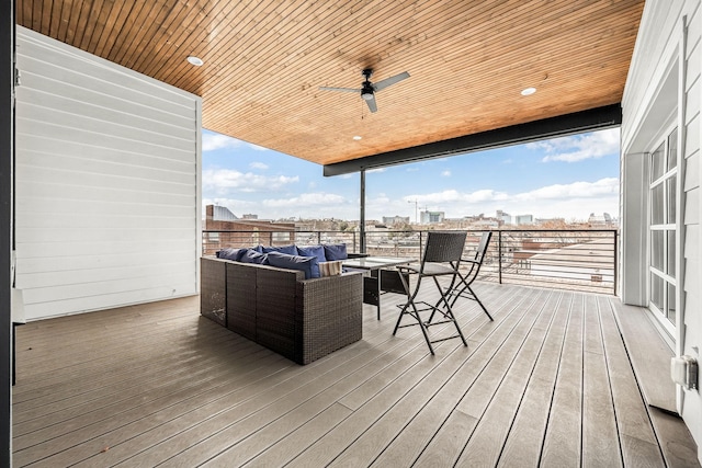 wooden terrace featuring a ceiling fan, a view of city, and an outdoor hangout area