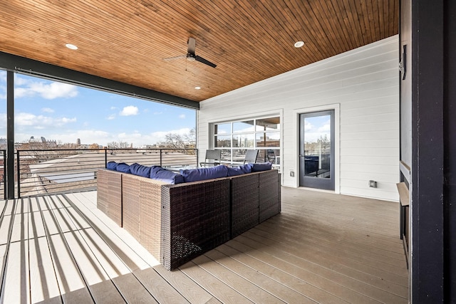 wooden terrace featuring an outdoor hangout area and a ceiling fan