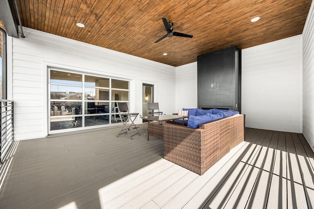 wooden terrace featuring an outdoor living space and a ceiling fan