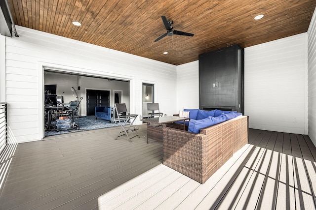 wooden terrace with ceiling fan and an outdoor hangout area