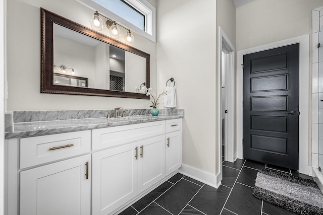 full bathroom featuring vanity, baseboards, and tile patterned floors