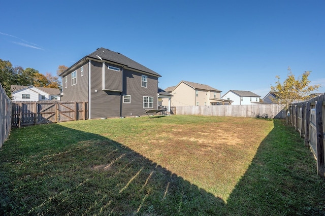 view of yard featuring a fenced backyard and a residential view