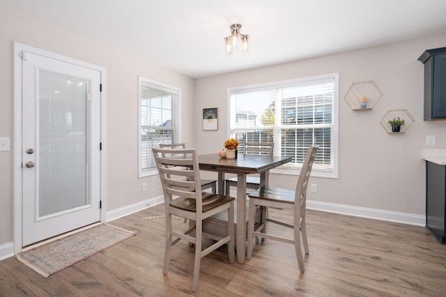 dining area featuring baseboards and wood finished floors