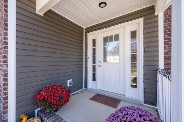 doorway to property featuring brick siding