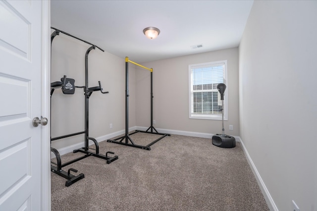 exercise area with carpet, visible vents, and baseboards