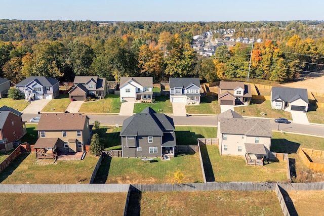 birds eye view of property with a forest view and a residential view