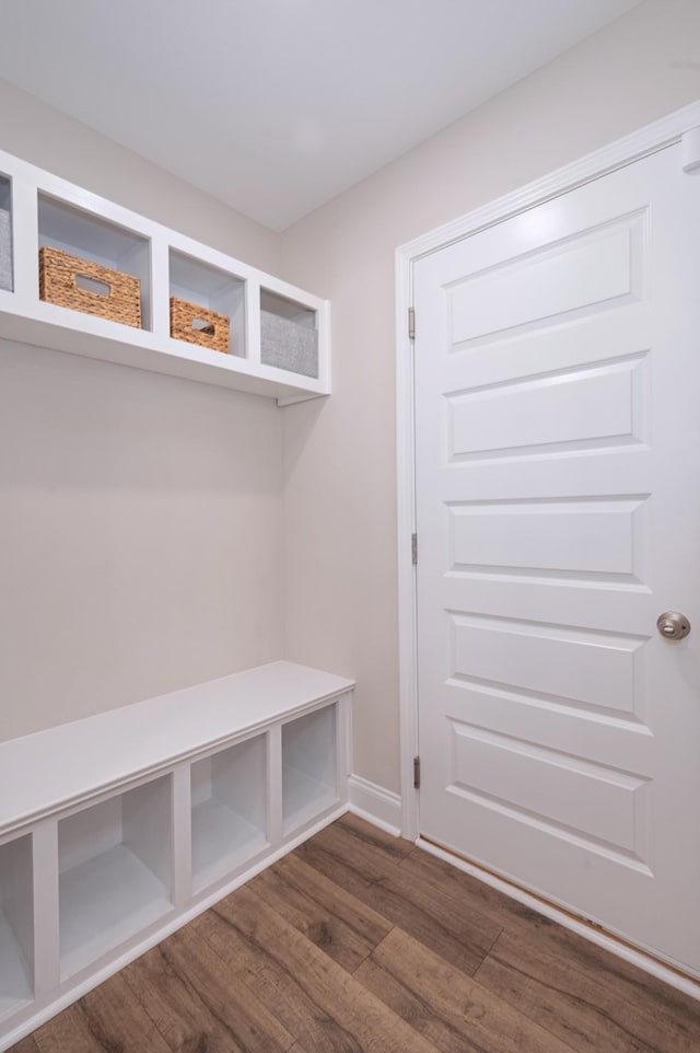 mudroom featuring dark wood finished floors and baseboards