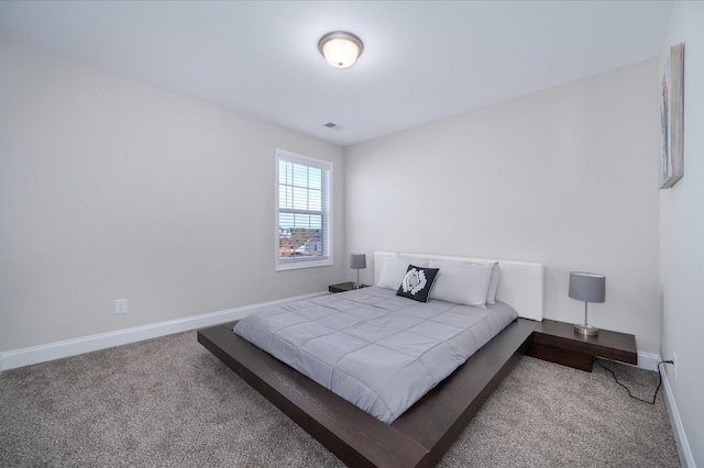 carpeted bedroom featuring visible vents and baseboards