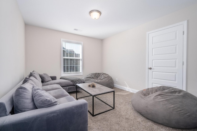 living room with visible vents, baseboards, and carpet flooring