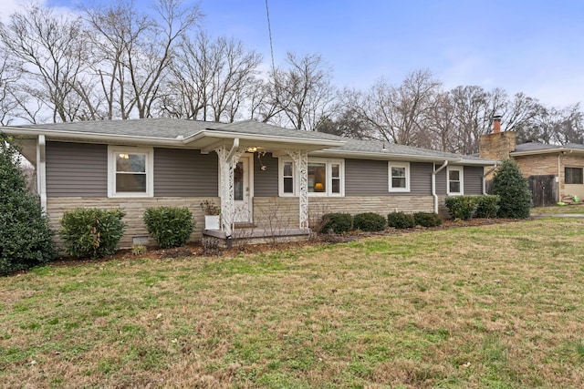 single story home featuring stone siding, roof with shingles, and a front lawn