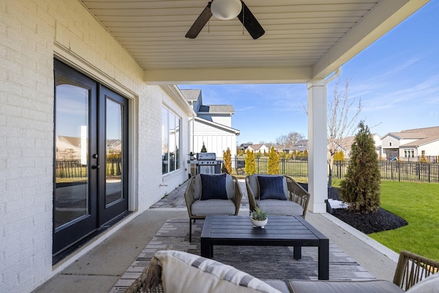 view of patio with ceiling fan, outdoor lounge area, fence, area for grilling, and a residential view