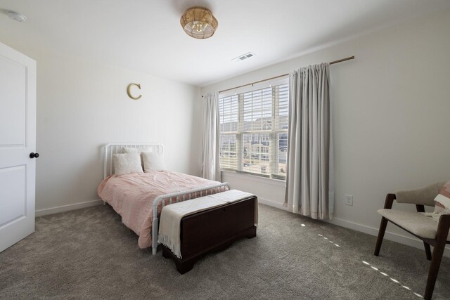 carpeted bedroom featuring visible vents and baseboards