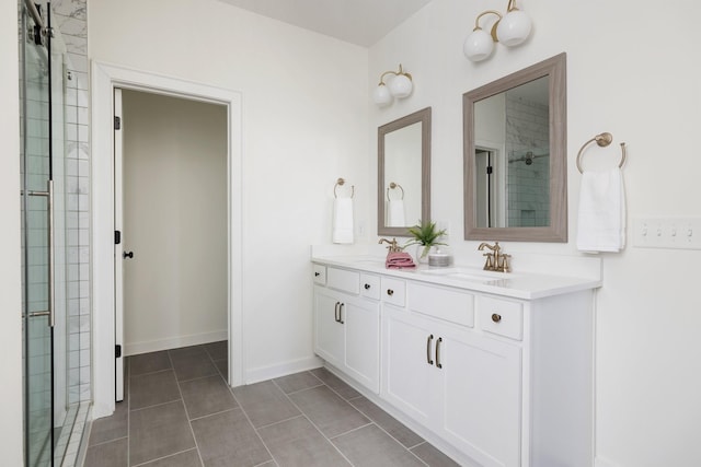 bathroom featuring double vanity, baseboards, a sink, and tiled shower