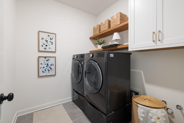 laundry room with cabinet space, washer and clothes dryer, baseboards, and light tile patterned floors