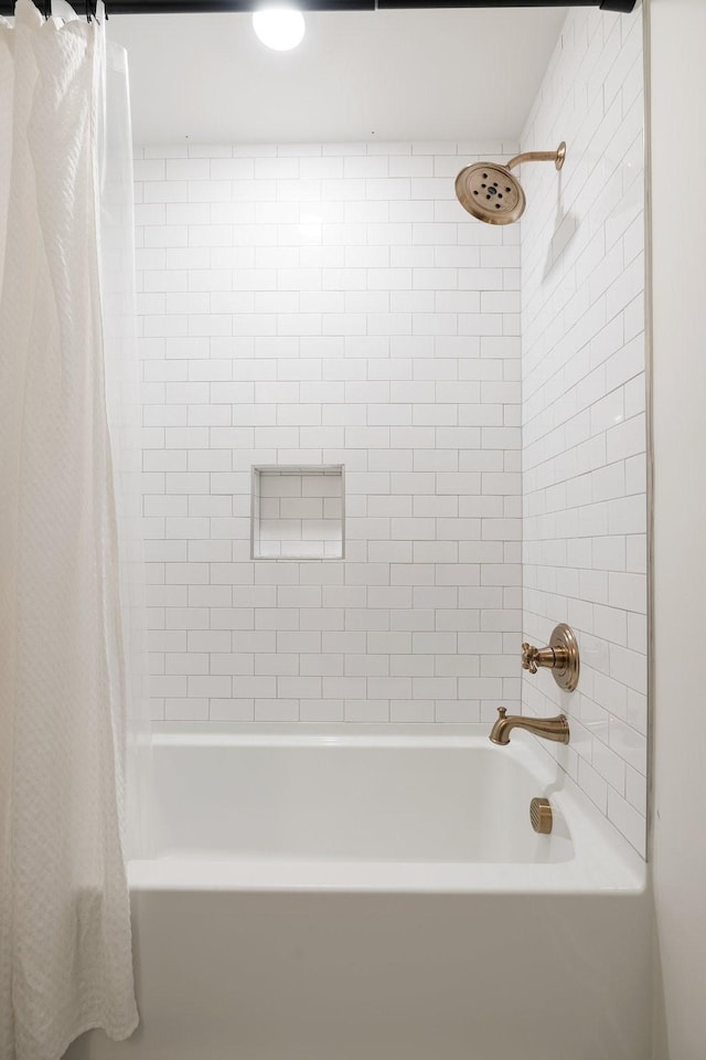 bathroom with shower / bath combo with shower curtain