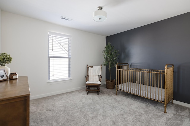 carpeted bedroom with visible vents and baseboards