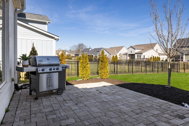 view of patio / terrace featuring a grill, a residential view, and fence