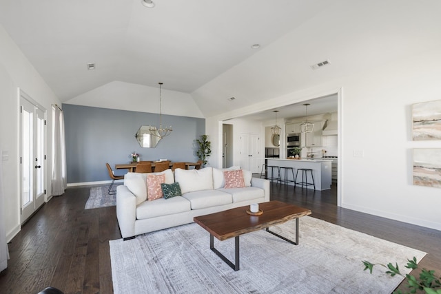 living room with lofted ceiling, visible vents, baseboards, dark wood finished floors, and an inviting chandelier