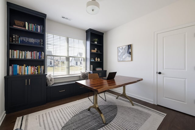 home office featuring dark wood-style floors, visible vents, and baseboards