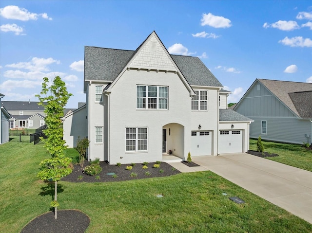 view of front of property featuring a shingled roof, concrete driveway, fence, and a front lawn