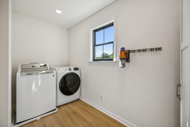 clothes washing area featuring recessed lighting, laundry area, baseboards, independent washer and dryer, and light wood finished floors