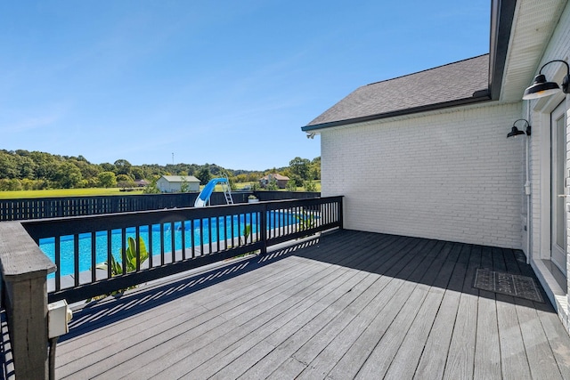 wooden terrace with a fenced in pool