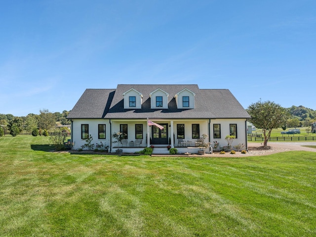 view of front of property featuring a front yard, covered porch, and fence