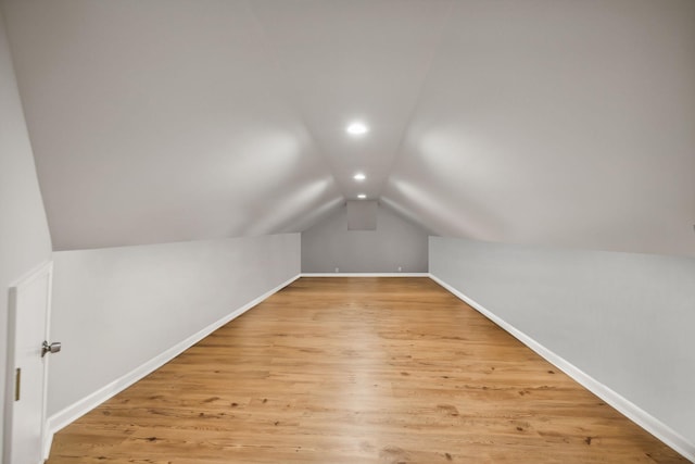 bonus room featuring light wood-style floors, recessed lighting, vaulted ceiling, and baseboards