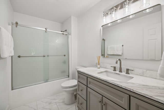 bathroom featuring marble finish floor, vanity, toilet, and bath / shower combo with glass door